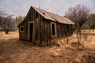 An outbuilding on the historic T-Bar Ranch Homestead, now abandoned. A snow storm was moving into this area at the time of the photograph. The land is owned by the Coconino National Forest and is public property. No release is needed.