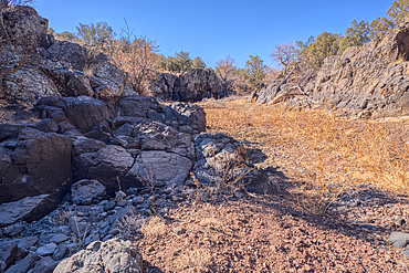 Basalt boulders and cliffs in a section of Johnson Canyon just east of the Bainbridge Steel Dam Lake near Ash Fork Arizona in the Kaibab National Forest.