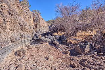 Basalt boulders and cliffs in a section of Johnson Canyon halfway between the Bainbridge Steel Dam and Stone Dam near Ash Fork Arizona in the Kaibab National Forest.