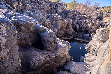 Dry waterfall cliffs in a section of Johnson Canyon halfway between the Bainbridge Steel Dam and Stone Dam near Ash Fork Arizona in the Kaibab National Forest.