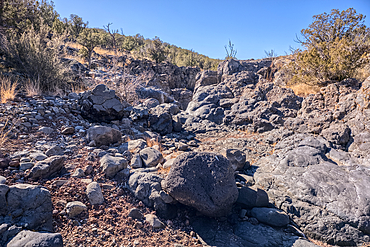 Basalt boulders and cliffs in a section of Johnson Canyon halfway between the Bainbridge Steel Dam and Stone Dam near Ash Fork Arizona in the Kaibab National Forest.