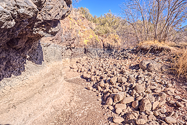 Basalt boulders and cliffs in a section of Johnson Canyon halfway between the Bainbridge Steel Dam and Stone Dam near Ash Fork Arizona in the Kaibab National Forest.