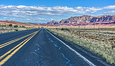 A mountain range called Echo Cliffs in northern Arizona viewed thru the windshield of a moving vehicle along US89.