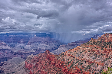 A rain storm over the North Rim of Grand Canyon National Park Arizona. Viewed from the Pipe Creek Vista on the South Rim.