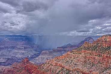 A rain storm over the North Rim of Grand Canyon National Park Arizona. Viewed from the Pipe Creek Vista on the South Rim.