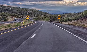 Approaching a steep grade on westbound I-40 near Ash Fork Arizona. Taken from a moving vehicle thru the windshield. There may be some motion blur.