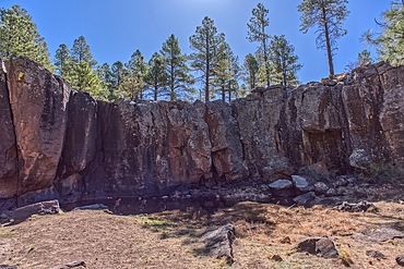 The cliff wall of the Keyhole Sink in the Kaibab National Forest near Williams Arizona. This sink is an open ended sinkhole where water can flow out of it.