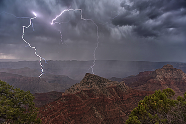 Lightning striking Freya's Castle viewed from Cape Royal on Grand Canyon North Rim Arizona.