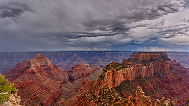 Panorama of storm clouds passing over Grand Canyon Arizona, viewed from Cape Royal on the North Rim. Composed of 3 photos stitched together.