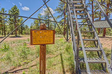 The 80 foot tall historic Fire Watchtower at Jacob Lake Arizona. Sign warns to climb the tower at your own risk. Maintained as a historic landmark by the National Forest Service. No property release needed.