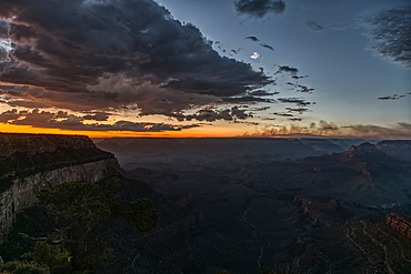 Smoke from the Dragon Bravo wildfire burning on the North Rim of Grand Canyon Arizona. Viewed from Shoshone Point on the South Rim at sundown. The fire started from a lightning strike on July 4th, 2025.