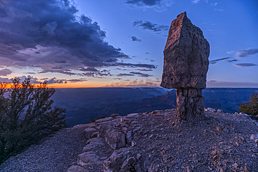 Smoke from the Dragon Bravo wildfire burning on the North Rim of Grand Canyon Arizona. Viewed from Shoshone Point on the South Rim at sundown. The fire started from a lightning strike on July 4th, 2025.