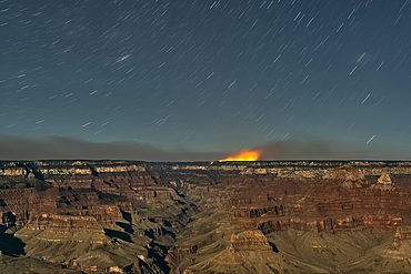 Dragon Bravo Wildfire on Grand Canyon North Rim viewed from Yavapai Point on South Rim Arizona at night under moonlight.