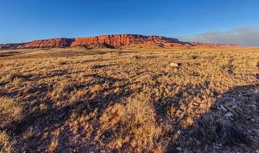 Vermilion Cliffs National Monument Arizona near sunset with smoke in the sky from the Dragon Bravo Wildfire burning on North Rim in the background.