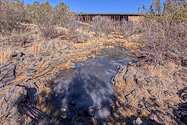 View from below the historic Bainbridge Steel Dam near Ash Fork Arizona in the Kaibab National Forest. It was originally constructed in the late 1800s and is now a historic landmark that is open to the public.