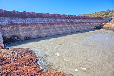 Top face view of the historic Bainbridge Steel Dam near Ash Fork Arizona in the Kaibab National Forest. It was originally constructed in the late 1800s and is now a historic landmark that is open to the public.