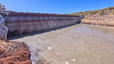 Top face view of the historic Bainbridge Steel Dam near Ash Fork Arizona in the Kaibab National Forest. It was originally constructed in the late 1800s and is now a historic landmark that is open to the public.