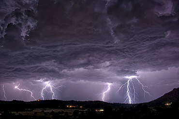 A long exposure capturing multiple lightning strikes on August 14th, 2025 on the south side of Sullivan Butte in Chino Valley Arizona.