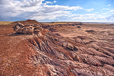 A desolate barren valley of rock and sand in Petrified Forest National Park Arizona just west of Blue Mesa.