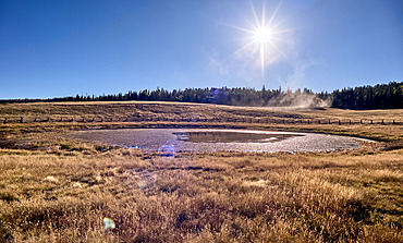Deer Lake Sinkhole on the Kaibab Plateau in northern Arizona near sunset. The wood fence is to keep cattle from getting stuck in the hole.