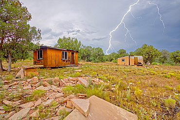 Lightning striking from a monsoon storm building up over the abandoned Mexican Quarry near Perkinsville, Arizona, United States of America, North America