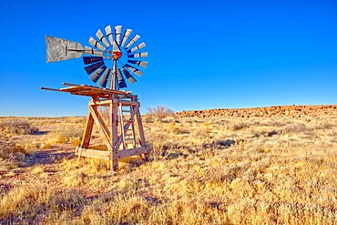 An old windmill marking the boundary of the Devil's Playground in Petrified Forest National Park, Arizona, United States of America, North America