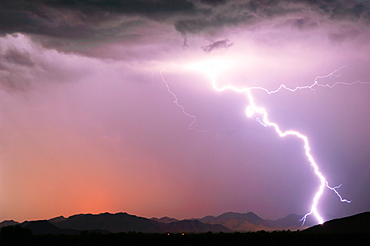 A bright lightning strike illuminating the Buckeye Foothills in Arlington during the 2012 Monsoon season, Arizona, United States of America, North America