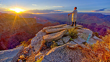 A hiker watching the sun go down west of Moran Point at Grand Canyon, Grand Canyon National Park, UNESCO World Heritage Site, Arizona, United States of America, North America