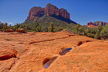 Reflections of Courthouse Butte in the Slick Rock Bowls along the Llama Trail in Sedona, Arizona, United States of America, North America