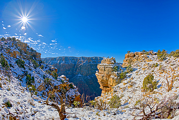 Ancient Indian ruins on a small rock island just right of center along the Palisades of the Desert at Grand Canyon Arizona.