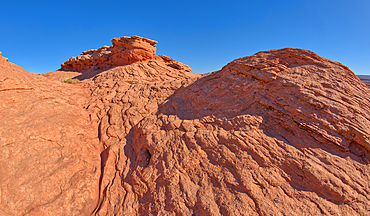 A wavy sandstone hill, a fossilized sand dune, at Ferry Swale in the Glen Canyon Recreation Area near Page, Arizona, United States of America, North America