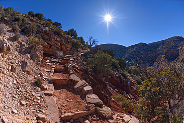 The very rocky pathway of the unmaintained Hermit Canyon Trail at Grand Canyon in winter with Waldron Canyon on the left in the distance, Grand Canyon, Arizona, United States of America, North America