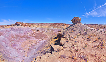 A lone hoodoo rock on the edge of a ridge overlooking the Jim Camp Wash on the south end of Petrified Forest National Park, Arizona, United States of America, North America