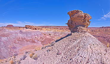 A lone hoodoo rock on the edge of a ridge overlooking the Jim Camp Wash on the south end of Petrified Forest National Park, Arizona, United States of America, North America