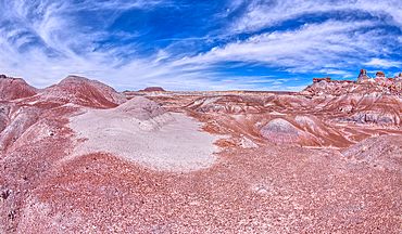 A small hill of gray bentonite clay that appears to be melting into the purple bentonite of Hamilili Valley on the south end of Petrified Forest National Park, Arizona, United States of America, North America