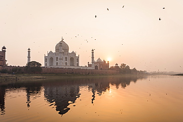 Taken from a boat on the River Yamuna behind the Taj Mahal at sunset, UNESCO World Heritage Site, Agra, Uttar Pradesh, India, Asia