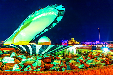 Oyster and Pearl Monument with fountain illuminated at night, celebrating the past pearl industry in Qatar, Doha, Qatar, Middle East