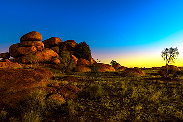 Outback landscape of Devils Marbles rock formations after twilight, granite boulders of Karlu Karlu (Devils Marbles) Conservation Reserve at dusk in Northern Territory, Australia, Pacific