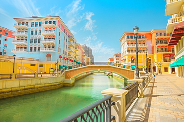 Beautiful Little Venice with canals connected by bridges in Venetian style and colourful houses in picturesque Qanat Quartier, Venice at the Pearl, Doha, Qatar, Middle East