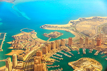 Aerial view of the Pearl-Qatar, the luxurious modern artificial island in the Persian Gulf, Venice at Qanat Quartier, Marsa Malaz Kempinski hotel and towers of Porto Arabia, Doha, Qatar, Middle East.