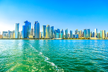 Cityscape of Doha West Bay skyline from boat trip in Doha Bay at sunset light, Doha, Qatar, Middle East