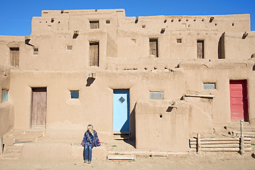 Woman visitor at Taos Pueblo, UNESCO World Heritage Site, Taos, New Mexico, United States of America, North America