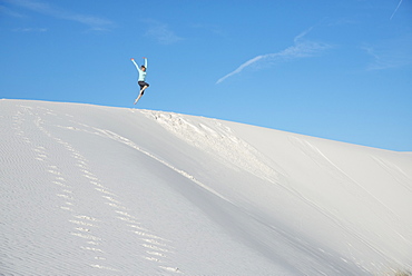 Jumping off a sand dune in White Sands National Park, New Mexico, United States of America, North America