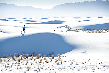 Jogging along a dune's ridge in White Sands National Park, New Mexico, United States of America, North America