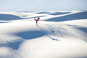 Stretching with a yoga pose in White Sands National Park, New Mexico, United States of America, North America