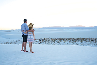 A couple enjoy White Sands National Park at sunset, New Mexico, United States of America, North America