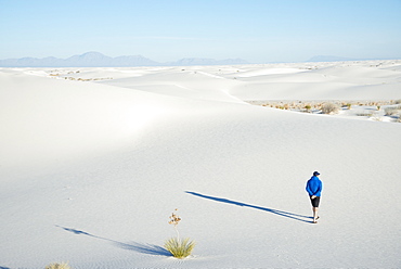 A man exploring the vast landscape of White Sands National Park, New Mexico, United States of America, North America