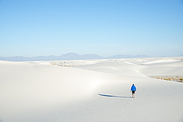 A man exploring the vast landscape of White Sands National Park, New Mexico, United States of America, North America