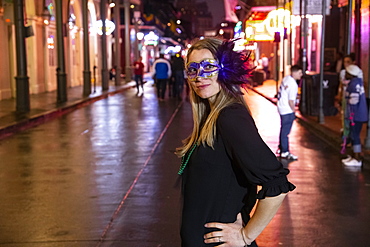 Woman ready to celebrate Mardis Gras on Bourbon Street in the French Quarter of New Orleans, Louisiana, United States of America, North America