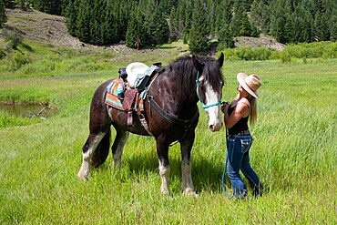 A woman enjoys a moment with her horse in rural British Columbia, Canada, North America